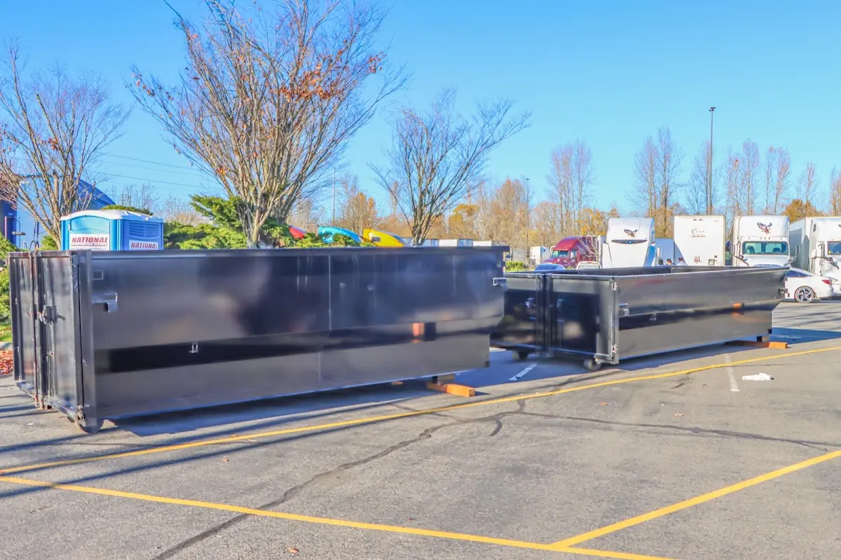 Professional dumpster rental service with roll-off container on residential driveway in Sturtevant